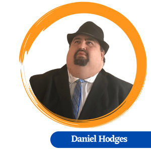 Daniel Hodges headshot, wearing a black fedora hat with a black suit and blue tie, surrounded by a painted yellow circle with a blue name tag below.